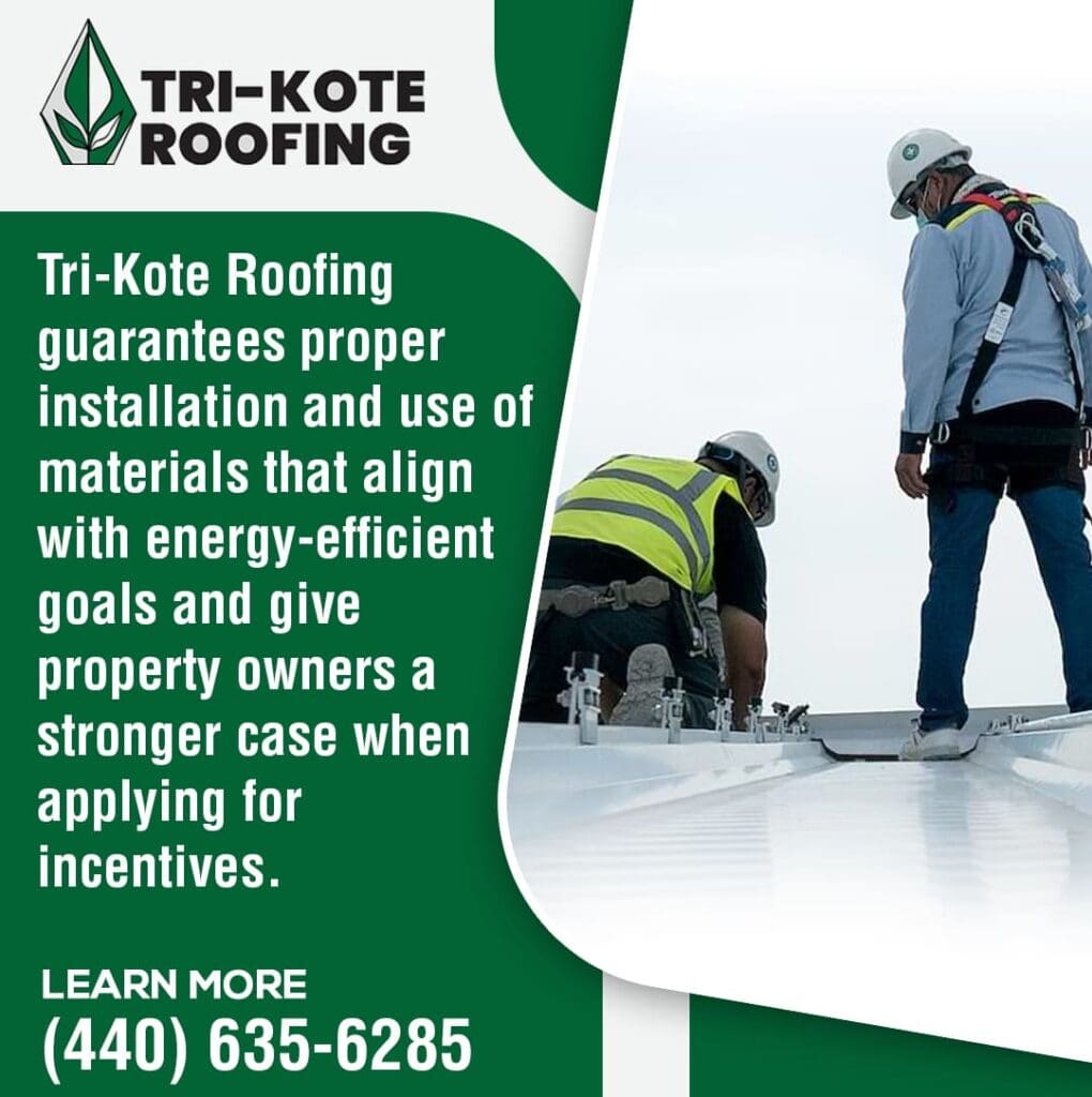 Two roofers in safety gear work on a commercial roof, installing components. One roofer is kneeling and adjusting a silver bracket, while the other stands nearby, overseeing the work. The sky is bright with some clouds.