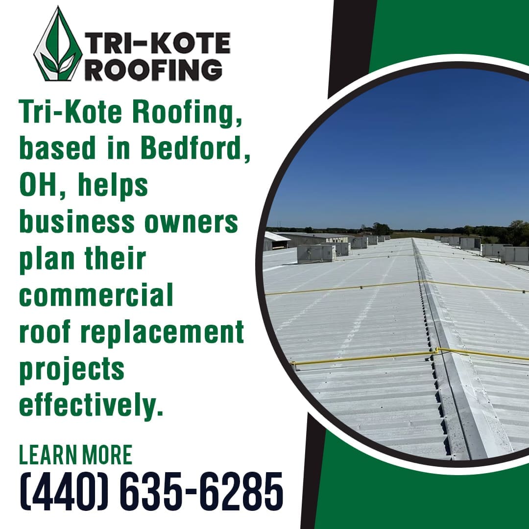 A view of a large white commercial roof with yellow safety ropes and several HVAC units, with a clear blue sky above.